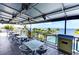 Enjoy outdoor dining with stunning water views on this covered patio with comfortable seating and a ceiling fan at 315 Sapphire Lake Dr # 202, Bradenton, FL 34209
