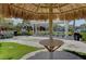 Outdoor picnic area with thatched umbrella, barbecue grills, and shaded seating for community gatherings at 315 Sapphire Lake Dr # 202, Bradenton, FL 34209