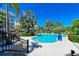 Upscale community pool surrounded by lush landscaping, comfortable seating, and luxurious amenities at 315 Sapphire Lake Dr # 202, Bradenton, FL 34209