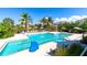 Beautiful community pool offers a refreshing escape with ample seating and stunning tropical surroundings at 315 Sapphire Lake Dr # 202, Bradenton, FL 34209