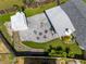 An aerial view of the backyard featuring a paved seating area and a storage shed at 3458 Lalani Blvd, Sarasota, FL 34232