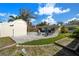 Spacious backyard with patio, fire pit seating, shed, and lush landscaping at 3458 Lalani Blvd, Sarasota, FL 34232
