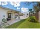 Backyard view featuring a covered patio, storage shed, and well-maintained lawn at 3458 Lalani Blvd, Sarasota, FL 34232