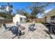 Backyard featuring a fire pit, outdoor seating, and storage shed at 3458 Lalani Blvd, Sarasota, FL 34232
