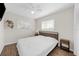 Bedroom with wood-look floors, ceiling fan, and large bright window at 3458 Lalani Blvd, Sarasota, FL 34232