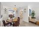 Inviting dining area with modern decor, including a pendant light fixture and tile floors at 3458 Lalani Blvd, Sarasota, FL 34232