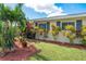 Well-manicured front yard, showing lush plantings against the exterior of the home at 3458 Lalani Blvd, Sarasota, FL 34232
