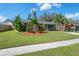 Inviting single-story home with a lush lawn and well-manicured landscaping, offering great curb appeal at 3458 Lalani Blvd, Sarasota, FL 34232