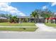 Inviting single-story home with a lush lawn and well-manicured landscaping, offering great curb appeal at 3458 Lalani Blvd, Sarasota, FL 34232