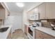 Well-lit kitchen with modern appliances, light wood cabinets, and ample counter space at 3458 Lalani Blvd, Sarasota, FL 34232