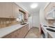Bright kitchen with white countertops, stainless steel sink, and light wood cabinetry at 3458 Lalani Blvd, Sarasota, FL 34232