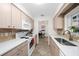 Modern kitchen with light cabinetry, white countertops, tile backsplash, and stainless steel appliances at 3458 Lalani Blvd, Sarasota, FL 34232