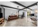 Bright living room with exposed beams, gray brick fireplace, and sliding doors to the backyard at 3458 Lalani Blvd, Sarasota, FL 34232