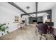 Bright living room with exposed beams, tile flooring, and multiple computer desks at 3458 Lalani Blvd, Sarasota, FL 34232