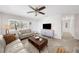 Inviting living room with a ceiling fan, large window, tile flooring, and comfortable seating arrangement at 3458 Lalani Blvd, Sarasota, FL 34232
