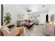 Cozy living room with neutral-toned furniture, large windows, tile flooring, and plenty of natural light at 3458 Lalani Blvd, Sarasota, FL 34232