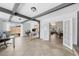 Bright living room featuring exposed beams, tile flooring, and glass doors to a private outdoor space at 3458 Lalani Blvd, Sarasota, FL 34232