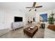 Bright living room featuring neutral walls, modern furnishings, ceiling fan, and tile flooring at 3458 Lalani Blvd, Sarasota, FL 34232