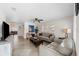 Bright living room featuring tile flooring, neutral paint, ceiling fan, and plenty of natural light at 3458 Lalani Blvd, Sarasota, FL 34232