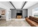 Living room with gray painted brick fireplace, exposed beams, and sliding doors to the backyard at 3458 Lalani Blvd, Sarasota, FL 34232