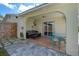 Covered outdoor patio with a comfortable seating area and access to the backyard at 3458 Lalani Blvd, Sarasota, FL 34232