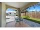 Covered outdoor patio featuring a dining set and view of the fenced yard at 3458 Lalani Blvd, Sarasota, FL 34232