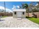 Newly constructed storage shed with a white door and paved surroundings at 3458 Lalani Blvd, Sarasota, FL 34232