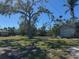 Spacious backyard with lush grass, a storage shed, and mature trees at 3808 118Th W St, Bradenton, FL 34210