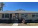 Classic single-story home featuring a new roof, large windows, and minimalist front landscaping at 3808 118Th W St, Bradenton, FL 34210