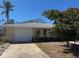 Charming single-story home with a garage, well-kept lawn, mature tree, and a sunny curb appeal at 3808 118Th W St, Bradenton, FL 34210