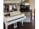 Open-concept living room with piano, aquarium, and seamless flow to the kitchen at 3808 118Th W St, Bradenton, FL 34210
