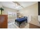 Well-lit secondary bedroom with a desk, hardwood floors and a ceiling fan at 4208 Central Sarasota Pkwy # 1422, Sarasota, FL 34238