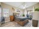 Cozy bedroom with a wooden bed frame, ceiling fan, and sliding glass doors to a balcony at 4208 Central Sarasota Pkwy # 1422, Sarasota, FL 34238
