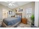 Bedroom featuring neutral walls, natural wood furnishings, ceiling fan and bright, shuttered windows at 4208 Central Sarasota Pkwy # 1422, Sarasota, FL 34238