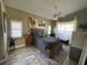Comfortable bedroom with a wooden bed frame, ceiling fan, and sunny windows at 4208 Central Sarasota Pkwy # 1422, Sarasota, FL 34238