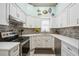 Bright kitchen featuring stainless steel appliances, modern cabinets, and decorative backsplash at 4208 Central Sarasota Pkwy # 1422, Sarasota, FL 34238