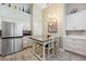 Well-lit kitchen with stainless steel appliances, dining island, and modern white cabinetry at 4208 Central Sarasota Pkwy # 1422, Sarasota, FL 34238