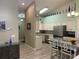 Modern kitchen featuring stainless steel appliances, an island with bar seating, and decorative bottles at 4208 Central Sarasota Pkwy # 1422, Sarasota, FL 34238