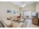 Comfortable living room with tan sofa, vaulted ceilings, and sliding glass doors to the outdoor lanai at 4208 Central Sarasota Pkwy # 1422, Sarasota, FL 34238