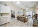 Open-concept living room with slider to lanai, neutral decor, and connection to the primary bedroom at 4208 Central Sarasota Pkwy # 1422, Sarasota, FL 34238