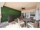 Outdoor patio with seating area, ceiling fan, and privacy wall with ivy at 4208 Central Sarasota Pkwy # 1422, Sarasota, FL 34238