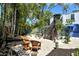 Secluded backyard oasis with comfortable seating, brick pavers, and lush tropical plants at 433 N Osprey Ave, Sarasota, FL 34236