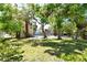 Lush backyard showcasing mature trees and partial view of charming home at 433 N Osprey Ave, Sarasota, FL 34236