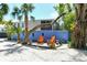 Outdoor deck area with Adirondack chairs, lush landscaping, and a charming beachside vibe at 433 N Osprey Ave, Sarasota, FL 34236