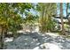 Gated backyard with bamboo, trees, and partial views of property at 433 N Osprey Ave, Sarasota, FL 34236