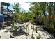 Cozy backyard space with stone paving, lush greenery, and outdoor dining area at 433 N Osprey Ave, Sarasota, FL 34236