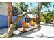 Cozy backyard deck with comfortable seating, surrounded by lush trees and charming landscaping at 433 N Osprey Ave, Sarasota, FL 34236