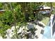 Overhead view of a lush backyard with stone paving, lush greenery, and a shed at 433 N Osprey Ave, Sarasota, FL 34236