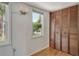 Bedroom with natural light from windows and a closet with wood louvered doors at 433 N Osprey Ave, Sarasota, FL 34236