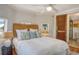 Comfortable bedroom featuring a rattan headboard and a convenient en-suite bathroom at 433 N Osprey Ave, Sarasota, FL 34236
